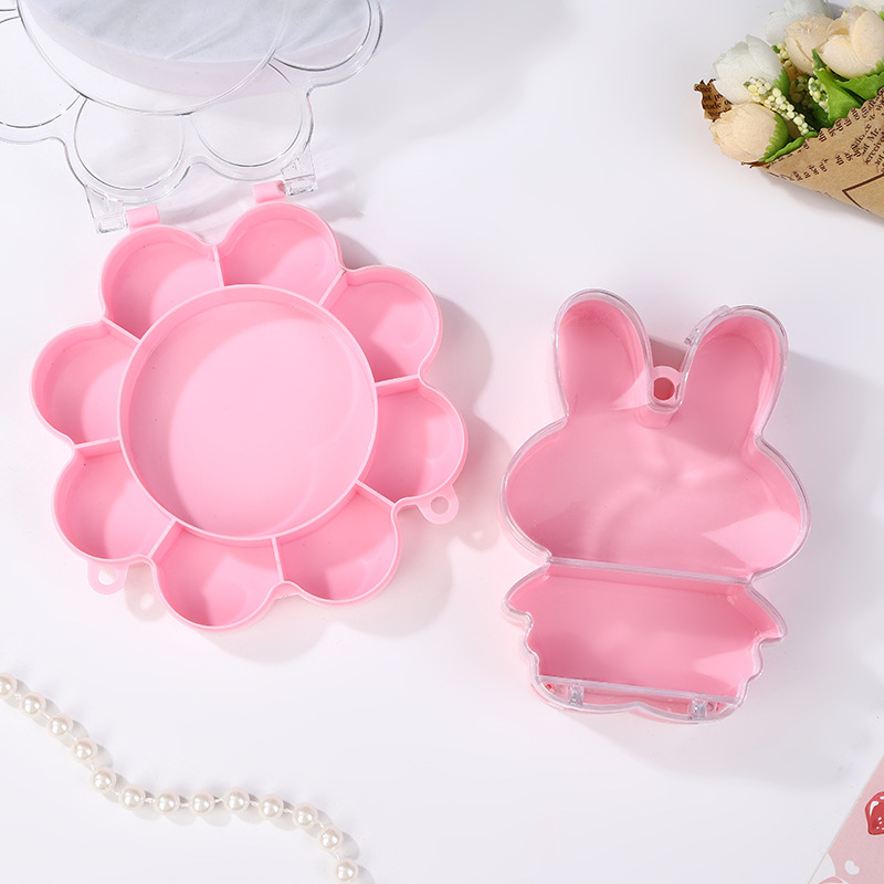 Cutie transparentă din plastic cu floare roz și iepuraș, capac rabatabil, compartimente pentru bijuterii și accesorii, design în stil castel