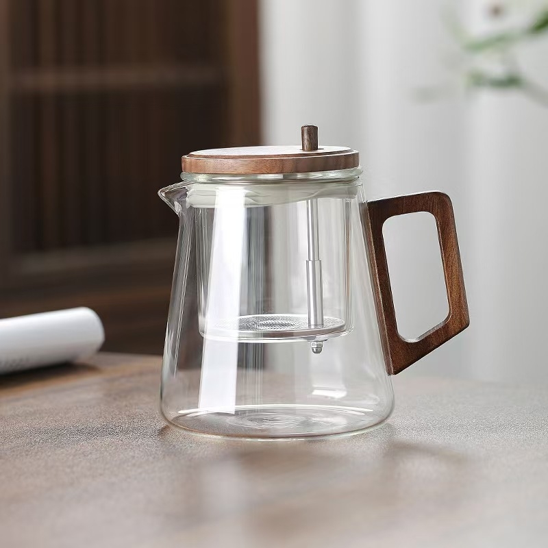 Ceainic din sticlă borosilikat, rezistent la temperaturi înalte, cu sistem de separare ceai-apă printr-un singur buton, design modern minimalist