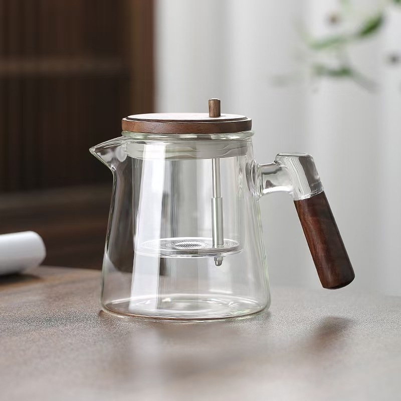 Ceainic din sticlă borosilikat, rezistent la temperaturi înalte, cu sistem de separare ceai-apă printr-un singur buton, design modern minimalist
