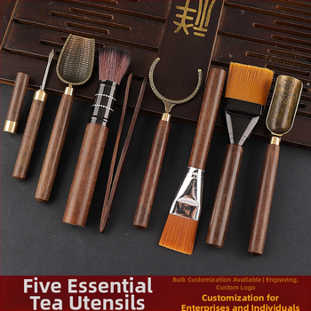 Set de accesorii pentru ceai din lemn de abanos cu cinci unelte: clemă pentru ceai, cuțit pentru ceai, lingură de ceai, furculiță pentru ceașcă și instrument de întreținere a ceainicului.