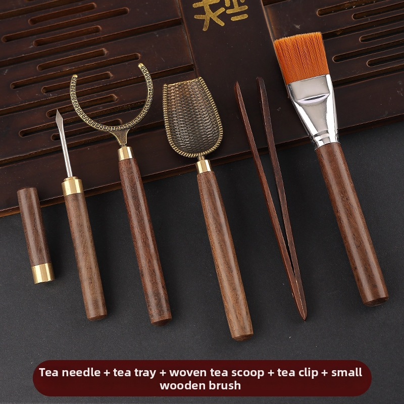Set de accesorii pentru ceai din lemn de abanos cu cinci unelte: clemă pentru ceai, cuțit pentru ceai, lingură de ceai, furculiță pentru ceașcă și instrument de întreținere a ceainicului.
