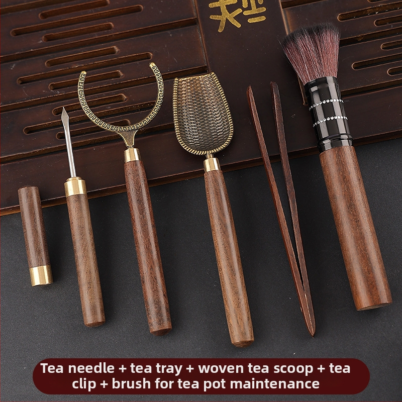 Set de accesorii pentru ceai din lemn de abanos cu cinci unelte: clemă pentru ceai, cuțit pentru ceai, lingură de ceai, furculiță pentru ceașcă și instrument de întreținere a ceainicului.