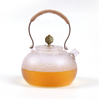 Ceainic din sticlă borosilicată cu mâner, model ciocănat; potrivit pentru plite electrice ceramice; poate fi folosit ca ceainic de ceai sau de apă, în formă de dovleac