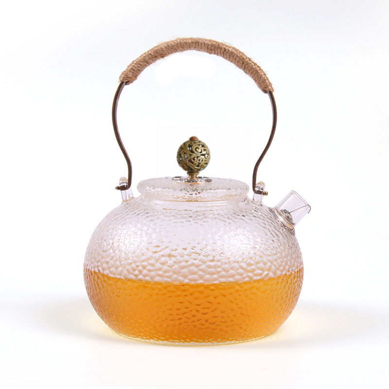 Ceainic din sticlă borosilicată cu mâner, model ciocănat; potrivit pentru plite electrice ceramice; poate fi folosit ca ceainic de ceai sau de apă, în formă de dovleac
