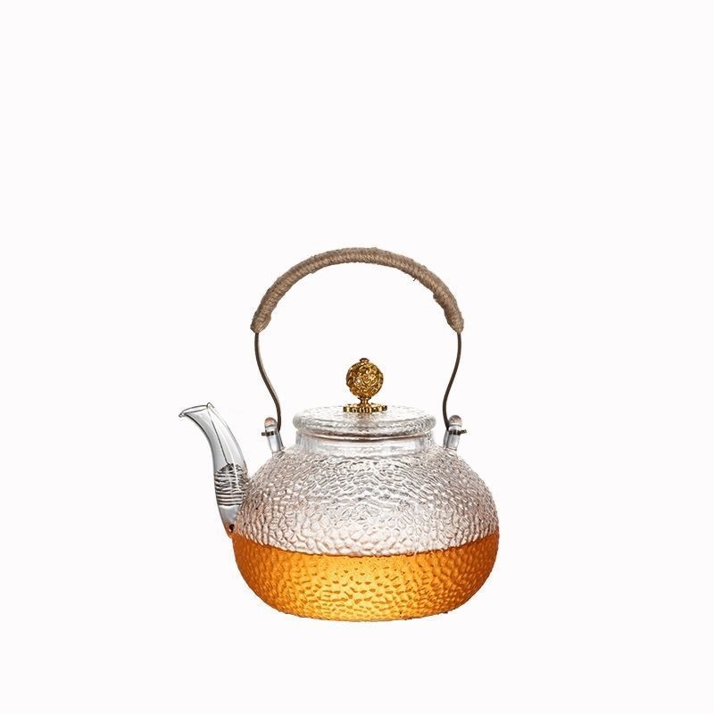 Ceainic din sticlă borosilicată cu mâner, model ciocănat; potrivit pentru plite electrice ceramice; poate fi folosit ca ceainic de ceai sau de apă, în formă de dovleac
