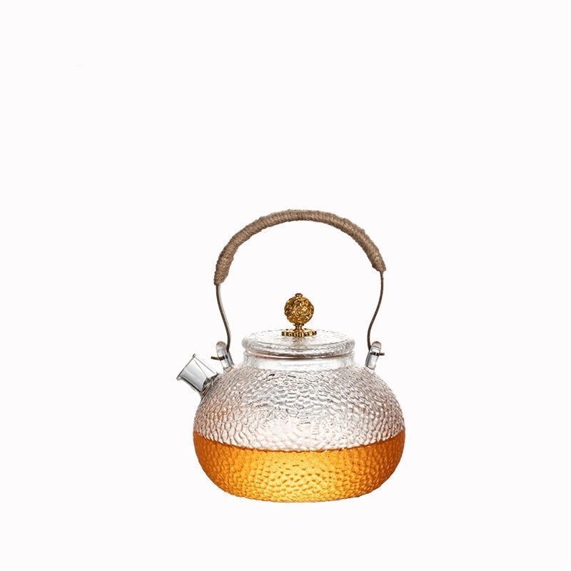 Ceainic din sticlă borosilicată cu mâner, model ciocănat; potrivit pentru plite electrice ceramice; poate fi folosit ca ceainic de ceai sau de apă, în formă de dovleac