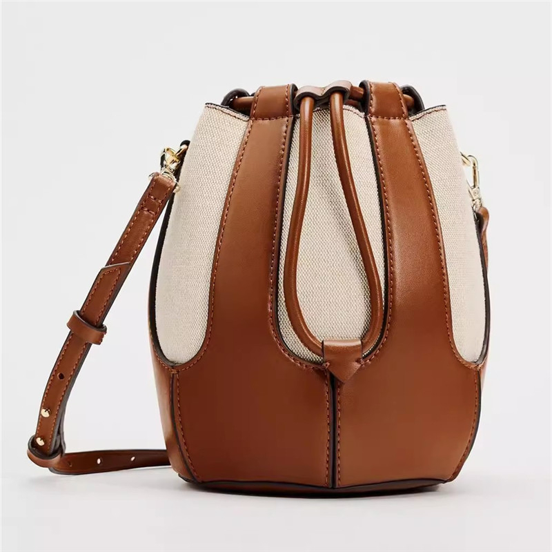 PU ženska bucket torbica, gradski minimalistički stil, kontrastno šivanje, crossbody remen na jedno rame, zatvaranje šnoru, srednje veličine