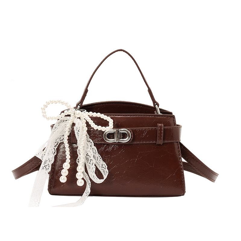Ženska Kelly torbica s nišnim dizajnom, lagani luksuz, novi model 2026, visoka kvaliteta, pogodna za rame ili crossbody.