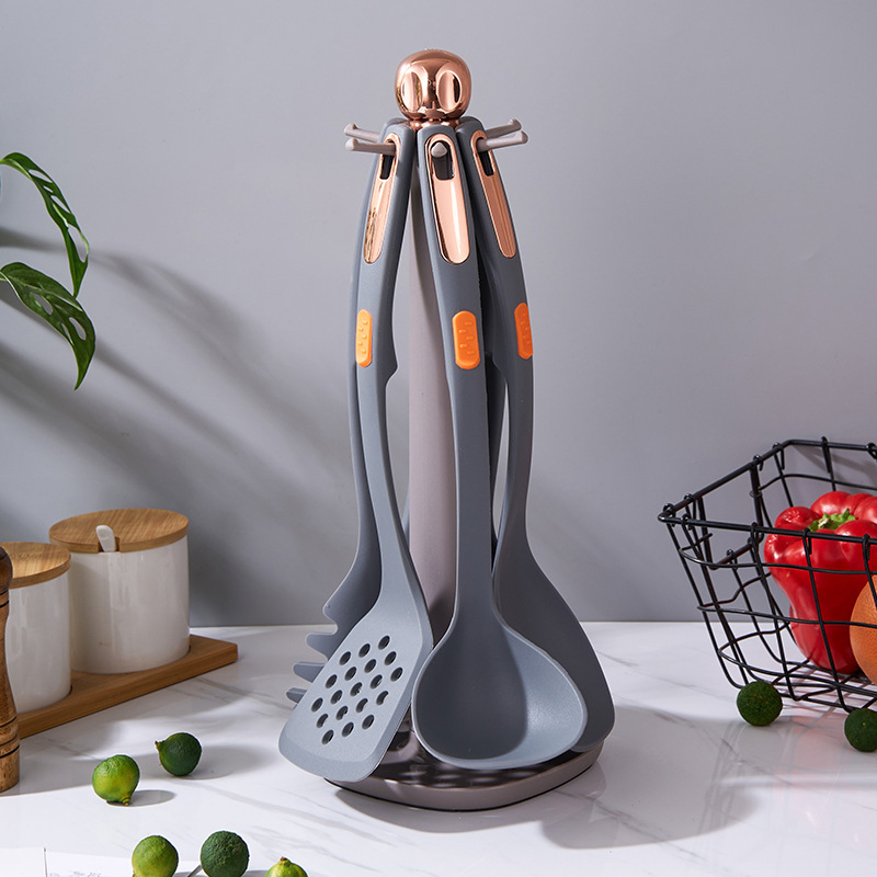 Set din silicon pentru bucătărie, 7 piese, cu suport de depozitare; include lingură și spatulă; rezistent la temperaturi înalte; antiaderent.