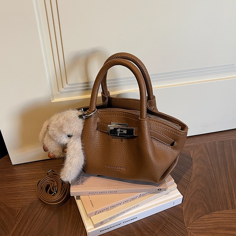 Női koreai stílusú bucket táska öv díszítéssel, 2026 téli modell, váll- és crossbody kivitel