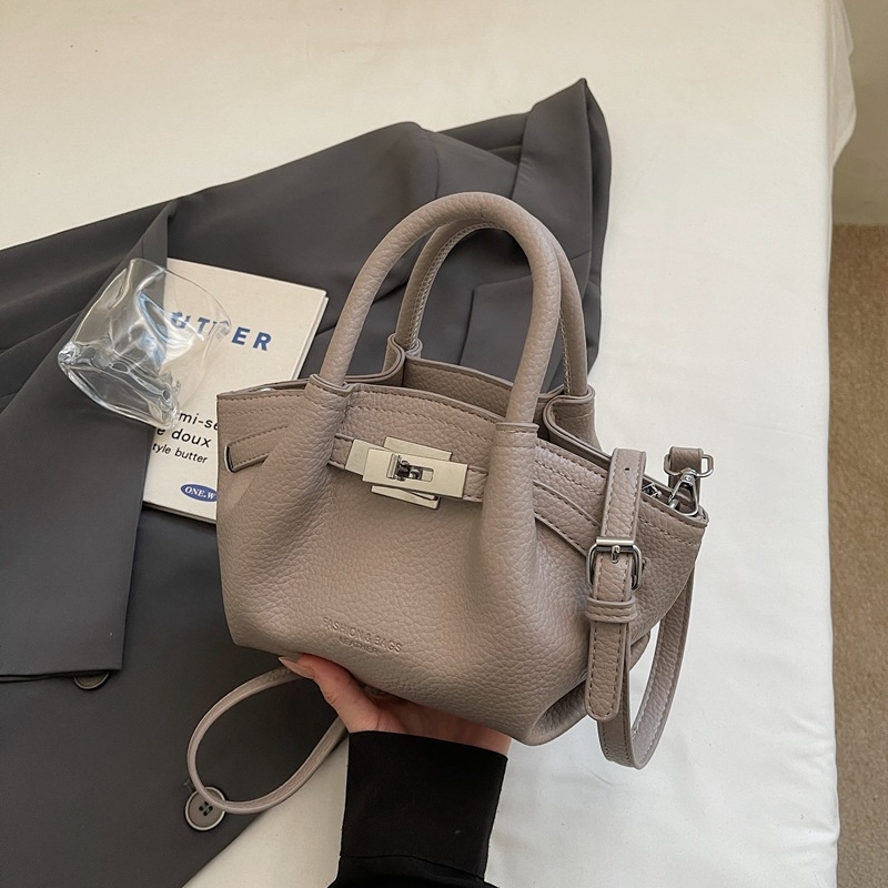 Női koreai stílusú bucket táska öv díszítéssel, 2026 téli modell, váll- és crossbody kivitel