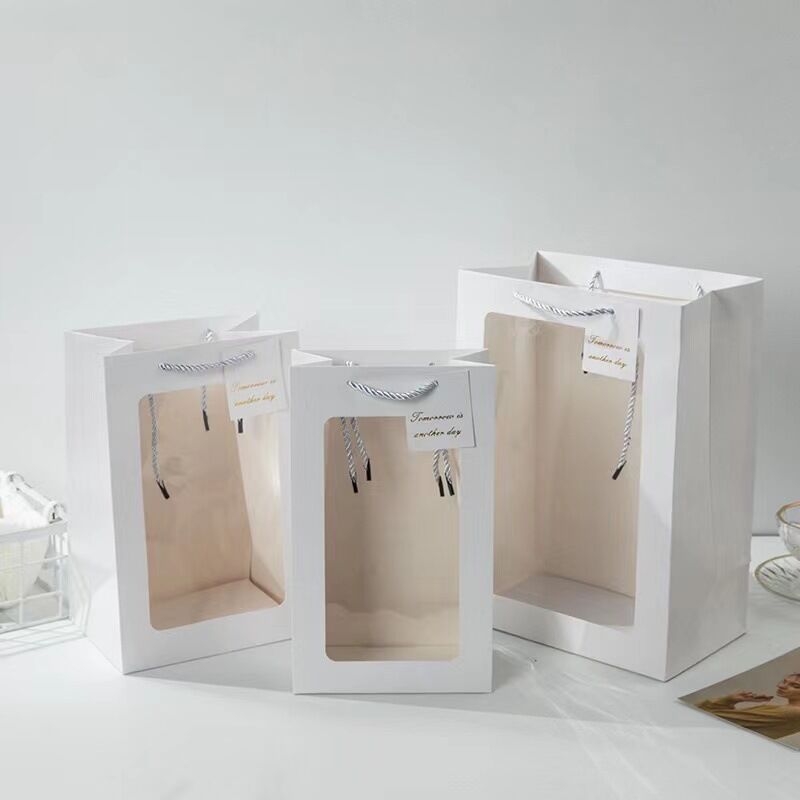 Geantă de cadouri din hârtie cu fereastră transparentă, mâner, bază pătrată, carton alb; ambalaj general. Disponibilă în negru, roz, roșu și alb (design vertical)