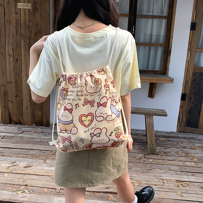 Retro nyuszis rajzokkal készült drawstring hátizsák vászonból, nagy kapacitású, nőknek, utazáshoz és iskolába, 2025 kiadás