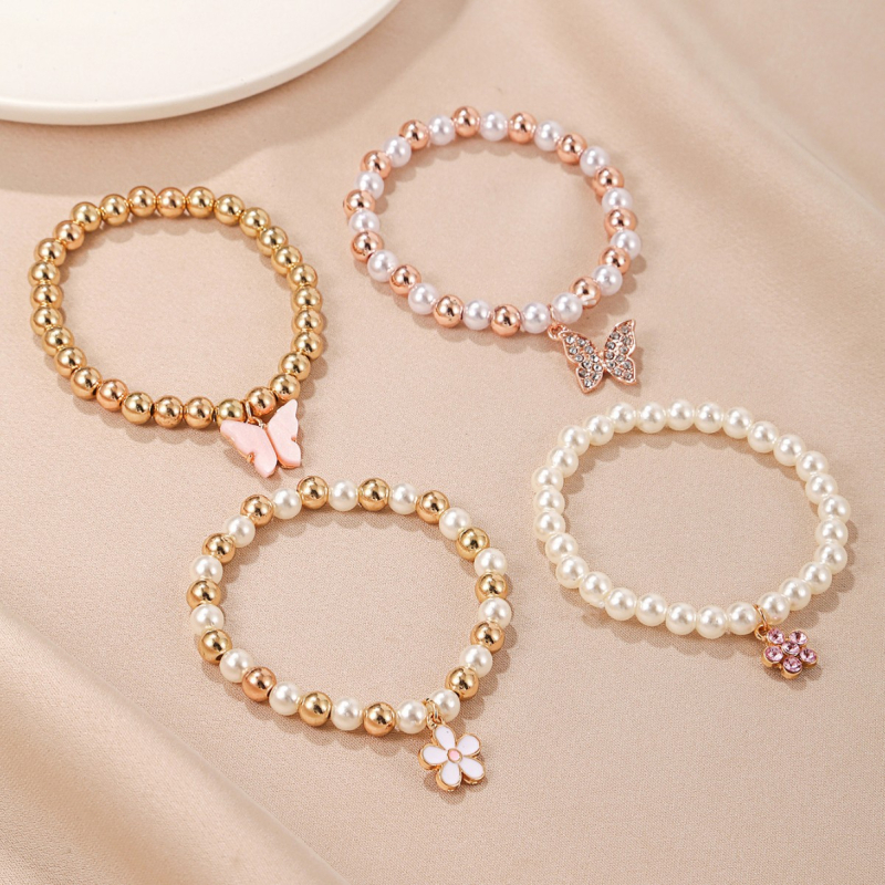 Ručno izrađeni set dječjih narukvica s privjescima: leptir, tratinčica i cvijet šljive