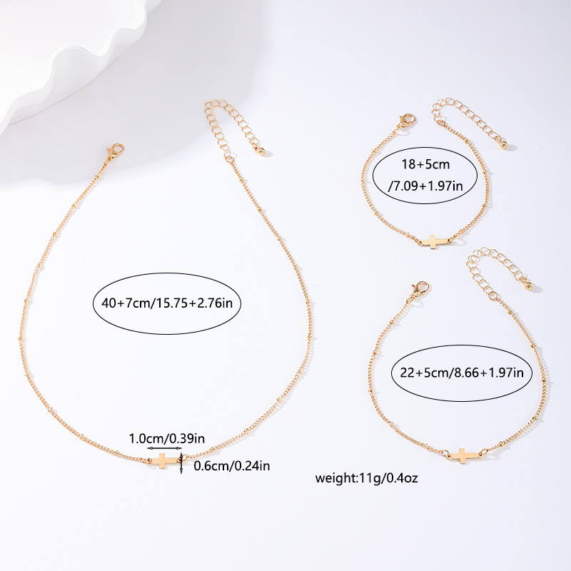 Ženski set: ogrlica, narukvica i gležnjak s metalnom lančastom križom – minimalistički stil