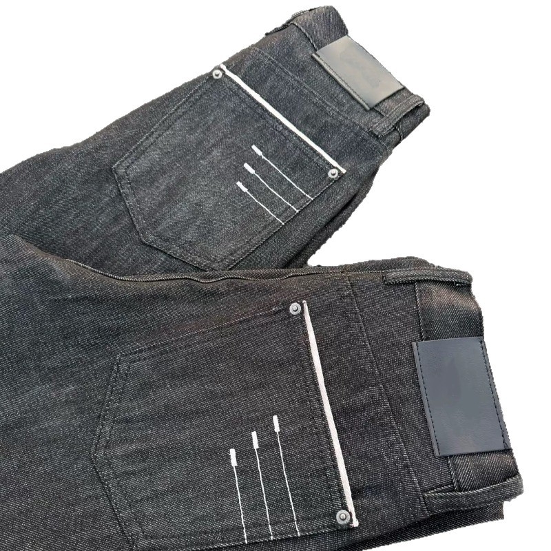 Uniszex fekete nyers denim farmer fekete hímzéssel, enyhén kiszélesedő szárú, egyenes szabás, mindennapi stílus