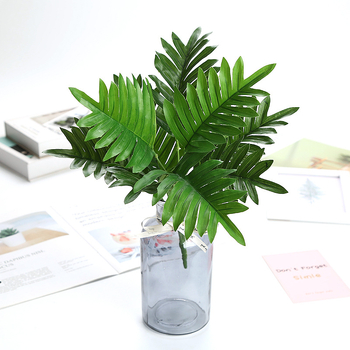 Plantă artificială cu buchet de frunze pe un copac de metal alb cu nouă ramuri, în ghiveci mic, pentru decor interior.