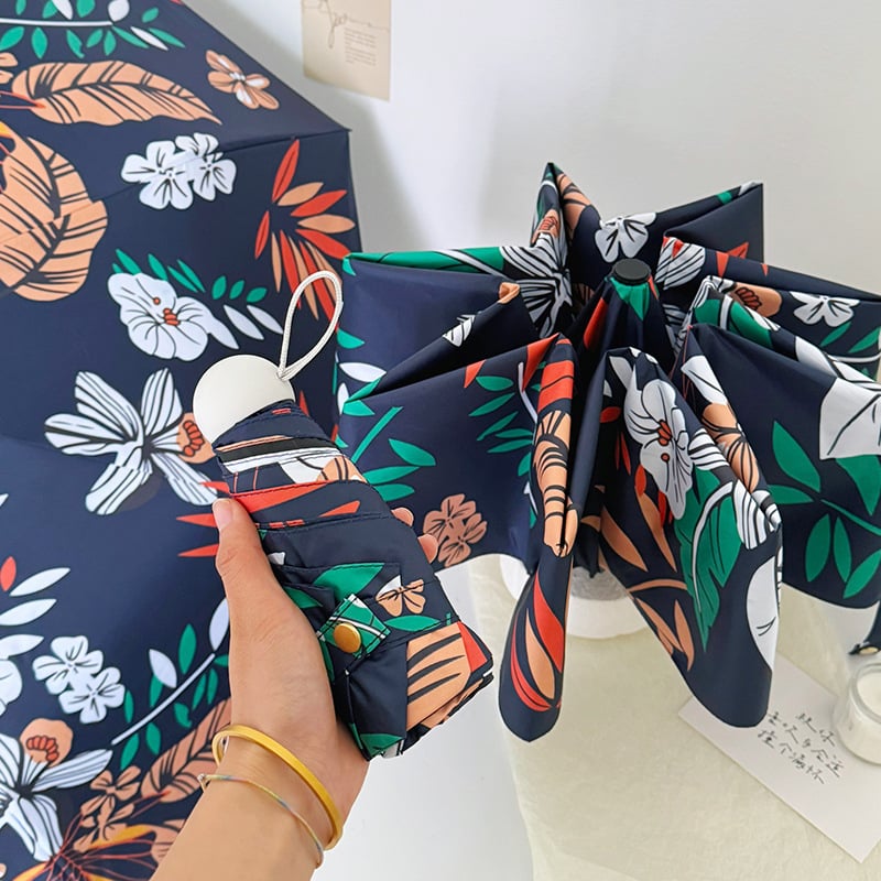 Umbrelă automată pliabilă cu trei secțiuni, imprimeu floral bleumarin, design compact tip capsulă de buzunar, protecție UV UPF50+