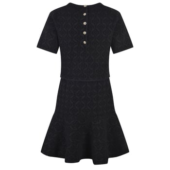 Set din două piese: top cu mânecă scurtă și guler rotund, în imprimeu retro, și fustă în stil fishtail cu margine în formă de frunză de lotus