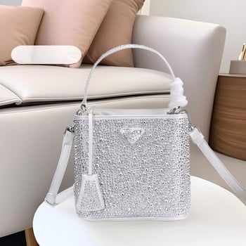 Geantă bucket nouă, primăvară-vară 2025, marca P, cu logo triunghi inversat și strasuri diamantate, purtată pe umăr sau crossbody
