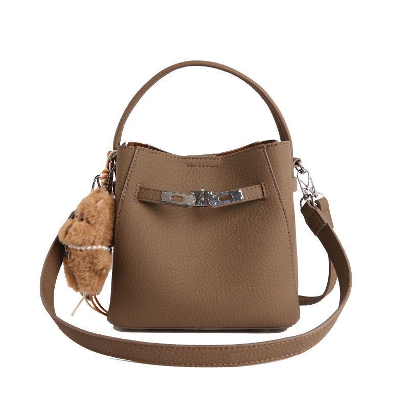 Geantă bucket pentru femei, crossbody, din PU, textură lychee, mărime medie, închidere magnetică, buzunar interior cu fermoar, utilizare zilnică, primăvara 2026.