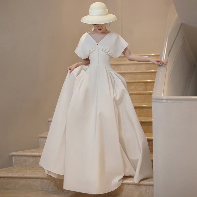 Rochie de mireasă în stil francez, satin alb, lungă, fără mâneci, decolteu adânc în V, inspirată de Hepburn pentru mici siluete, retro pentru ședințe foto de călătorie.