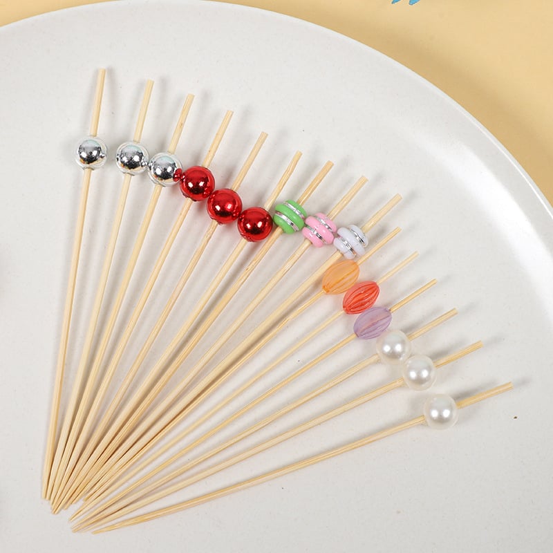 Bețișoare de fructe de unică folosință, cu design floral drăguț pe bețe de bambus, ideale pentru deserturi, sushi și decorarea fructelor.