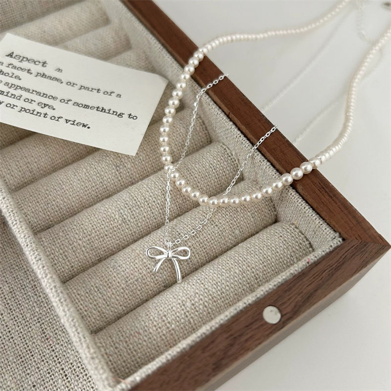 Colier femei cu pandantiv fundă, stil minimalist, cupru, lanț încrucișat, lungime 41–50 cm