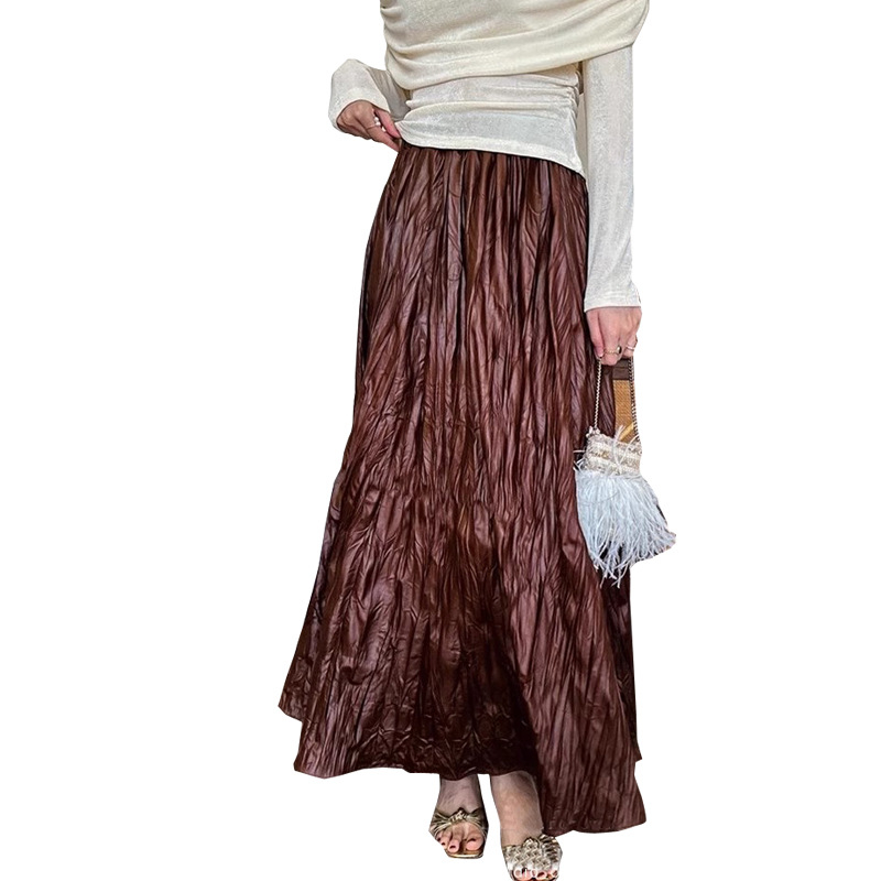 Trudničarska kožna suknja — jesenji francuski stil, retro elegantna, nepravilni plisirani detalji, srednja duljina, A-linija