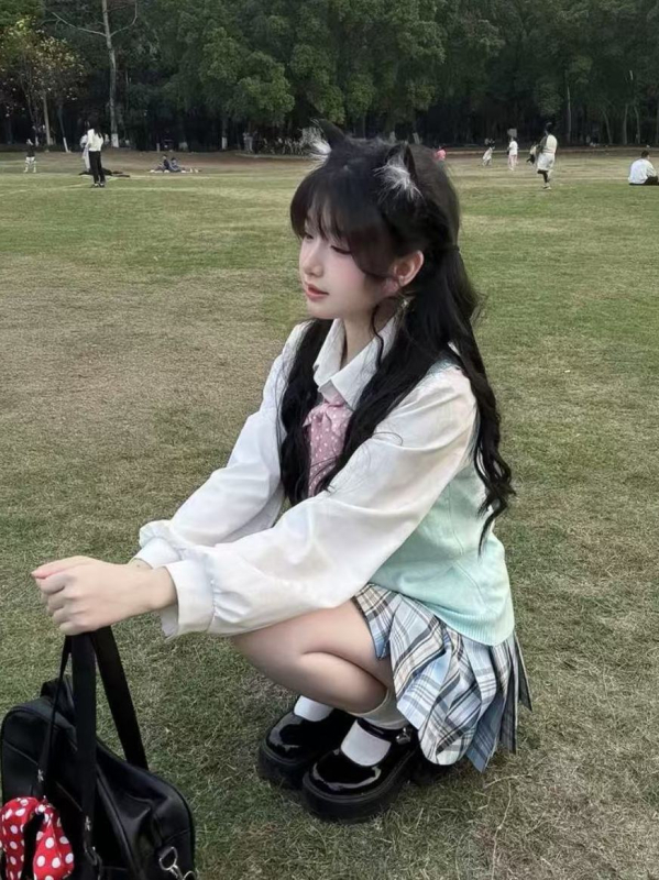Japán stílusú iskolai együttes: lazán szabott kék kockás szoknya, pulóver-mellény, lányoknak