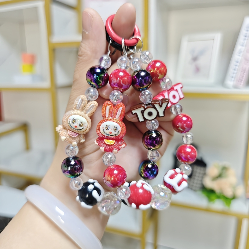 Rankų darbo audinio lėlė su karoliukais, pakabukas telefono grandinei, automobilio raktų pakabukas ir rankinės papuošalas – akrilas, animacinis stilius, atskirai įpakuota