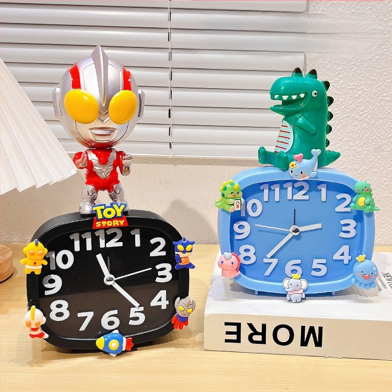 Bērniem paredzēts galda pulkstenis – karikatūru stilā, ar baterijām, izturīgs pret kritieniem (plastmasas korpuss, plastmasas cifernis)