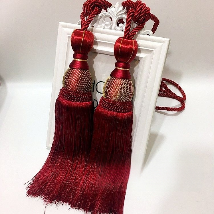 Aizkaru aukli - zelta stieples bumbiņa ar pušķi (audums)