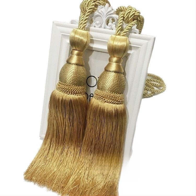 Aizkaru aukli - zelta stieples bumbiņa ar pušķi (audums)