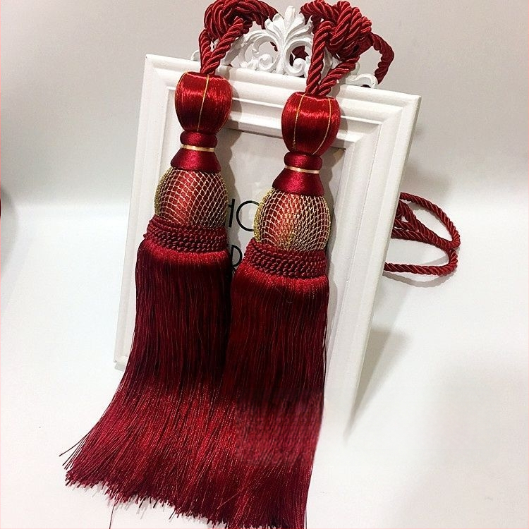 Aizkaru aukli - zelta stieples bumbiņa ar pušķi (audums)