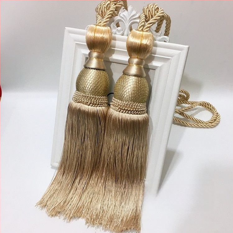 Aizkaru aukli - zelta stieples bumbiņa ar pušķi (audums)