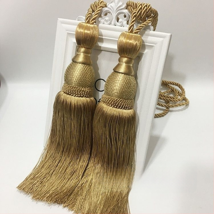 Aizkaru aukli - zelta stieples bumbiņa ar pušķi (audums)