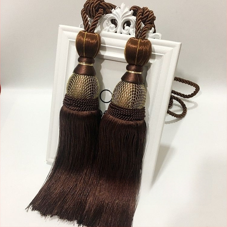 Aizkaru aukli - zelta stieples bumbiņa ar pušķi (audums)