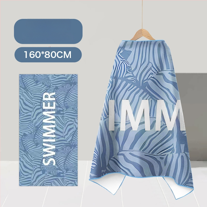 Nēsājamais mikroviļņu dvieļu pludmales pončo – ātri žūst, viegls, ar pogu kapuci; Materiāls: mikrofibra; Svars zem 100 g; Diegs: 150D; Jacquard aušana