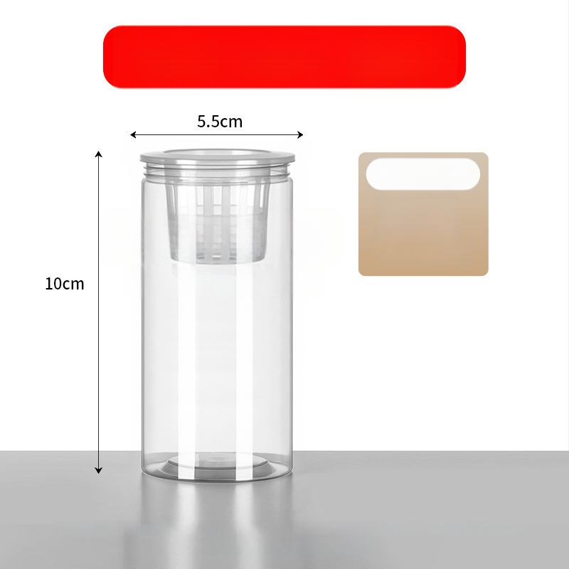 Caurspīdīgs plastmasas cilindrisks hydroponiskais pods sēklām un maziem augiem, stāvošs uz grīdas ar stādīšanas grozu, domāts mājas un dārza lietošanai