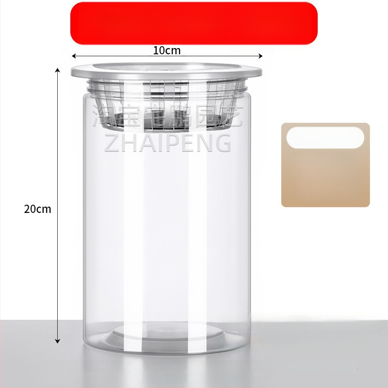 Caurspīdīgs plastmasas cilindrisks hydroponiskais pods sēklām un maziem augiem, stāvošs uz grīdas ar stādīšanas grozu, domāts mājas un dārza lietošanai