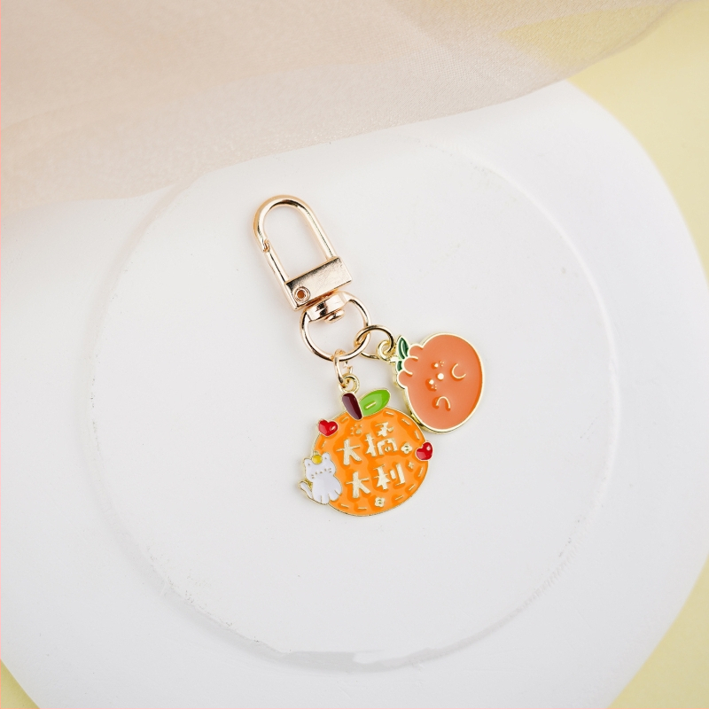 Fém kulcstartó medál – gyümölcs ihletésű szöveges dizájn és aranyos lányos karikatúra, táska kiegészítő, ajándék