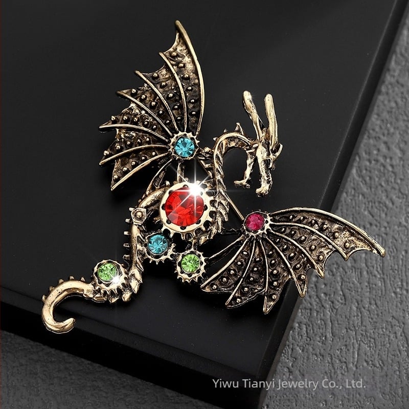 Broš iz legure, sa dijamantima, motiv letaćeg zmaja u crtanom stilu, unisex, modni dodatak