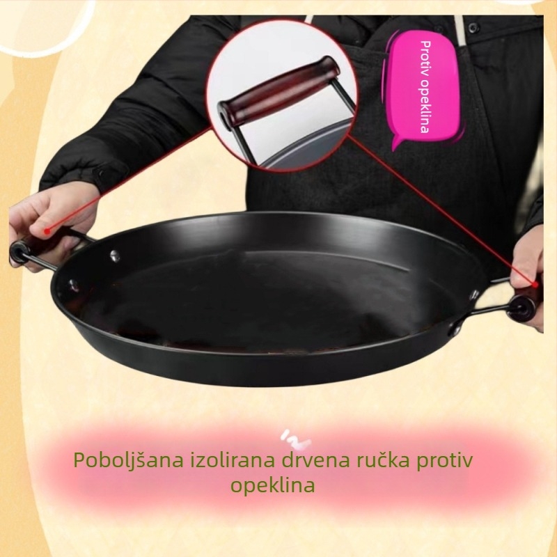 Tigan od kovanog željeza bez premaza, s dvjema ručkama, ravno dno, pogodan za plinske i indukcijske štednjake.