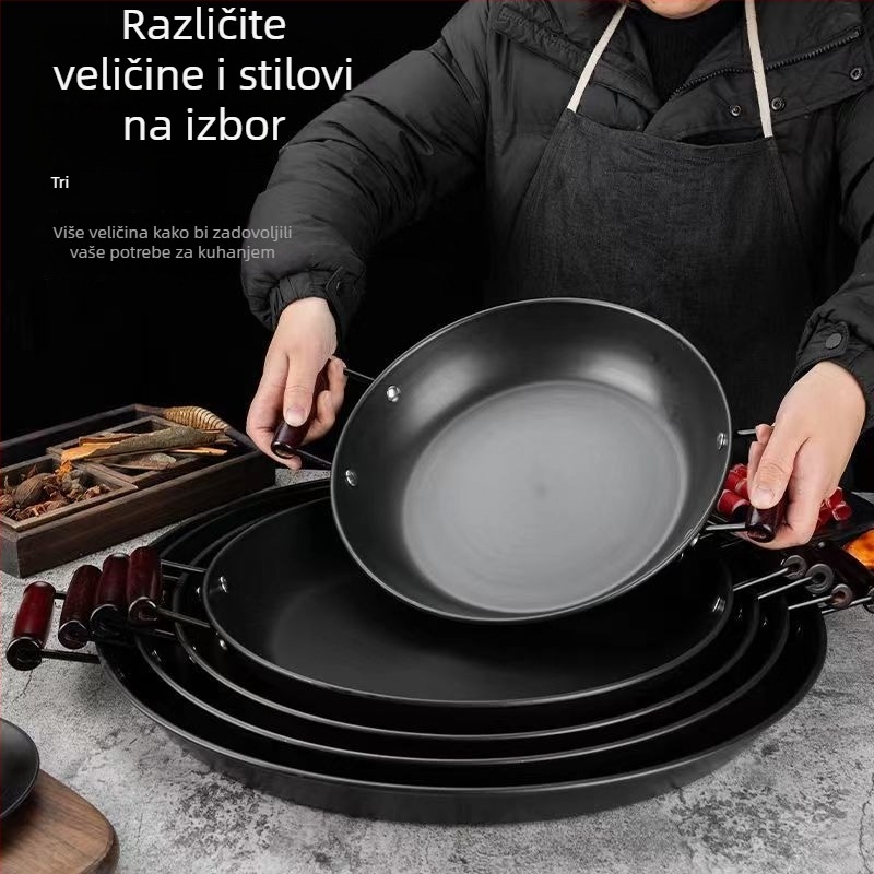 Tigan od kovanog željeza bez premaza, s dvjema ručkama, ravno dno, pogodan za plinske i indukcijske štednjake.