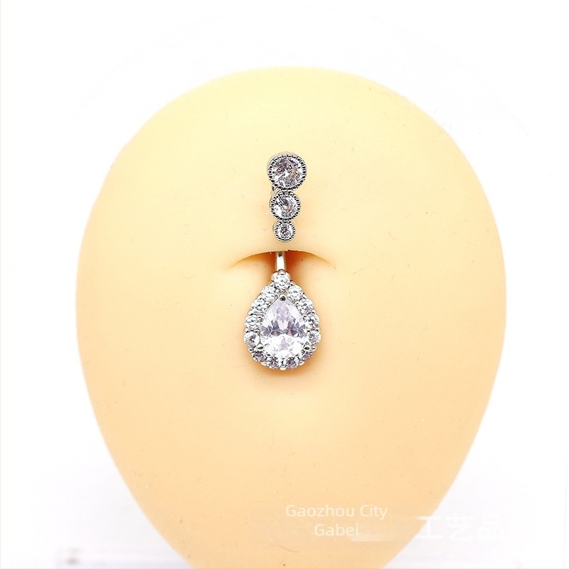 Piercing pupka - prsten pupka u obliku kapljice vode, tri cirkon kamenčića, kapljasti dizajn, unisex, crtani stil, mesing + bijela čelična