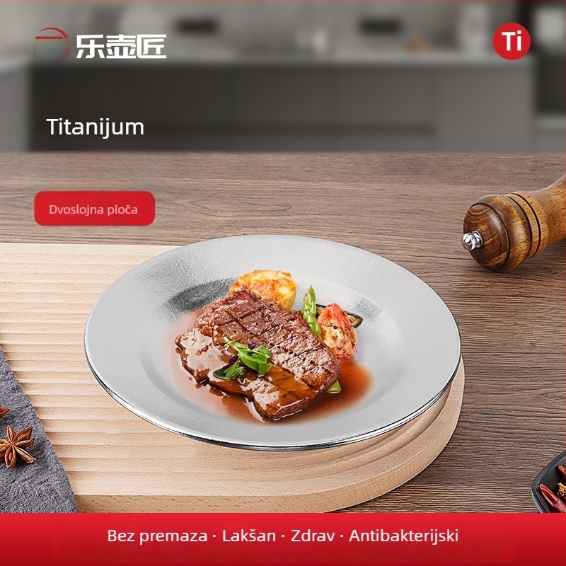 Tanjur od čistog titana, okruglog oblika, monolitno oblikovana površina, moderan minimalistički stil, jednofarbni dizajn