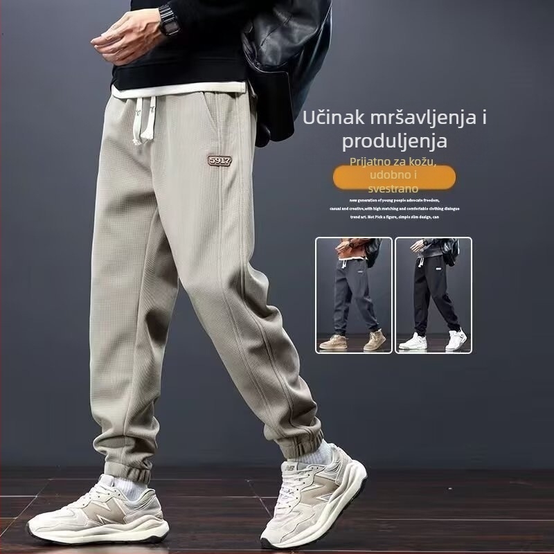 Muške zimske sportske hlače za opuštanje, s fleec iznutra, jednobojne boje, širokog kroja, s vezicom u struku i suženjem donjeg dijela uz gležanj, poliester