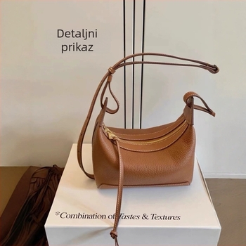 Torba preko ramena od prave kože, horizontalno kvadratnog oblika, zatvarač, unutarnji džepovi za telefon, dokumente i kameru, kožna podstava — gradska jednostavnost.