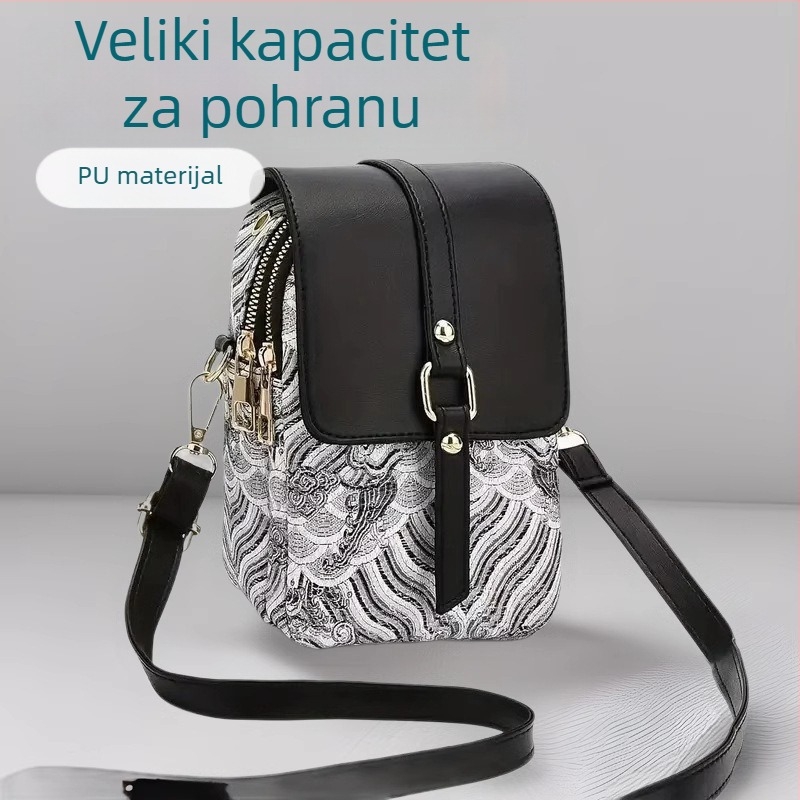 Crossbody torba od PU kože, vertikalnog kvadratnog oblika s poklopcem; zatvaranje poklopcem; unutarnji pretinci: džep sa zatvaračem, džep za mobitel, ID džep, laminirani džep; podstava od poliestera; jedan naramenica; brend Easy